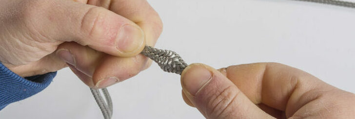 Hands tapering a splice on a grey Dyneema line
