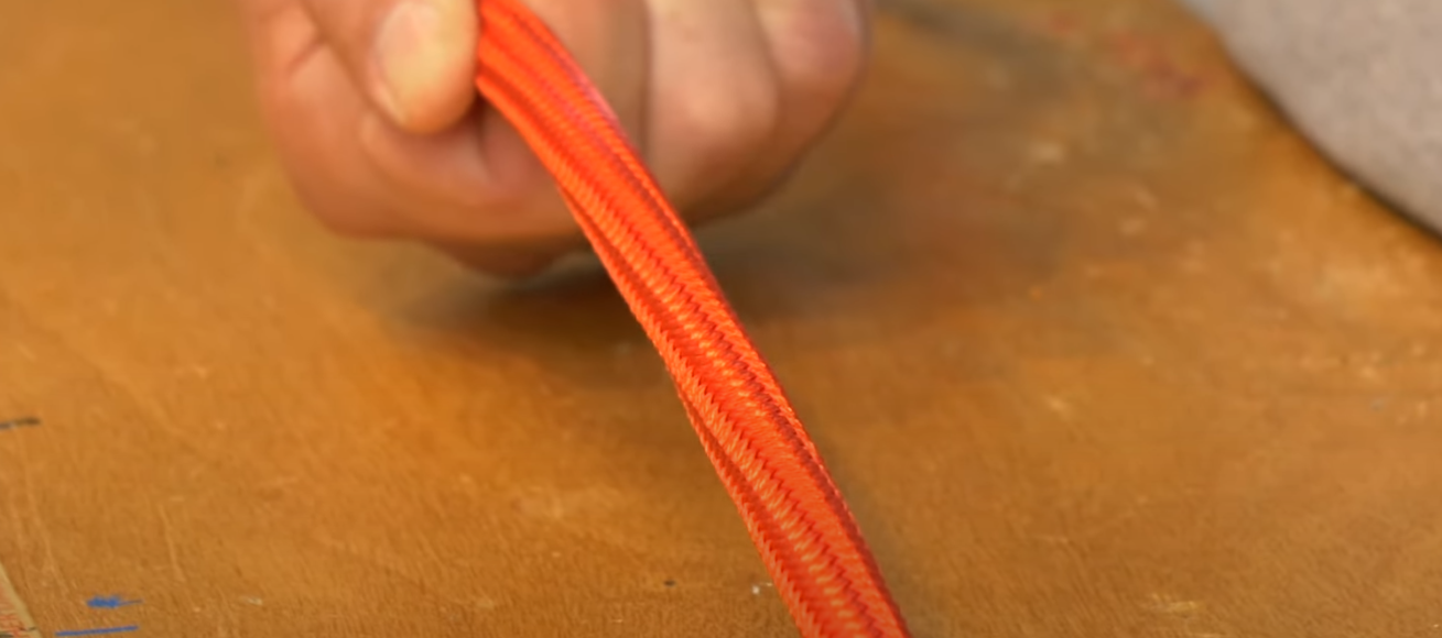 Twisted orange rope held in the hand