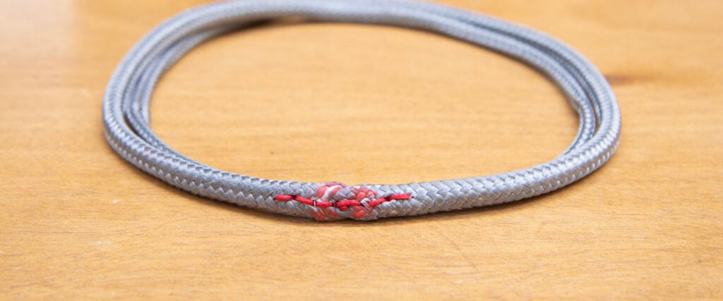 Grey Dyneema loop with its splice on a workbench