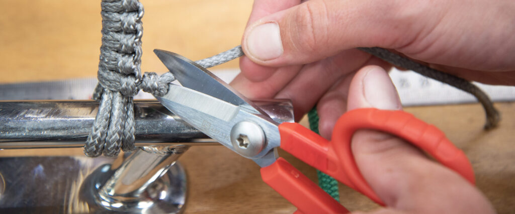 Cutting the tail of a Dyneema lashing on a stanchion