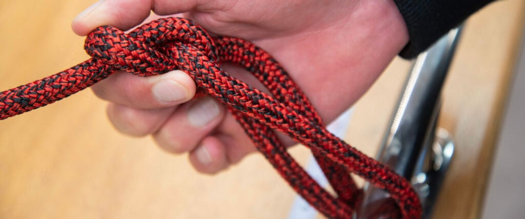 Tying a bowline knot on a red and black Dyneema rope